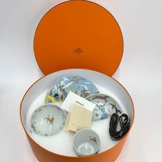 an orange box with some dishes inside of it