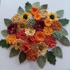 an arrangement of flowers made out of felt