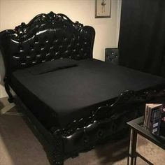 a bed with black leather headboard and foot board is shown in an instagramtion