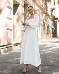 Fabric: Crepe Cotton 75%, Polyester 20%, Elastane 5% Puff sleeves Bustier bodice Midi Length Sleeve length: 70cm/ 27.5n Skirt length: 90cm/ 35.5in Ivory Elegant Cream Puff Sleeve Midi Dress, White Midi Length Puff Sleeve Dress, Feminine Beige Midi-length Puff Sleeve Dress, Luxury White Knee-length Puff Sleeve Dress, White Long-sleeved Midi Dress With Elastic Sleeves, Crop Top Shirts, Puff Sleeve Dresses, Dress Suits, White Midi Dress