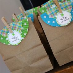 two brown paper bags with green and blue designs