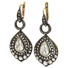 Statement Victorian inspired drop earrings. Vintage high jewelry. Approximately 7.40 carats total weight. 2 pear shape rose cut diamond earrings. Approximately 4 carats, L/M color grade, and VS clarity grade. Complimented by approximately 3.40 carats of round rose cut diamonds, I/J color, SI clarity.Gold & silver. *Missing 3 round rose cuts Accommodated with an up-to-date appraisal by a GIA G.G. once purchased, upon request. Please contact us with any questions. Item Number E3820 Luxury Pear-shaped Diamond Evening Earrings, Luxury Pear-shaped Single Cut Diamond Earrings, Formal Teardrop Single Cut Diamond Earrings, Elegant Pear-shaped Earrings With Single Cut Diamonds, Elegant Pear-shaped Single Cut Diamond Earrings, Pear-shaped Evening Diamond Earrings, Luxury Rose Cut Drop Diamond Earrings, Formal Pear-shaped Diamond Earrings With Single Cut Diamonds, Wedding Drop Diamond Earrings With Single Cut Diamonds