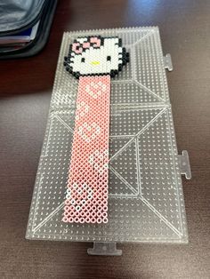 a hello kitty hamper made out of perler beads