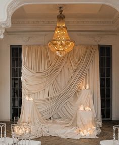 an elegant wedding setup with candles and drapes