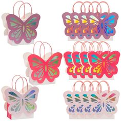 six butterfly shaped paper bags are shown in different colors and shapes, one is pink, the other is blue