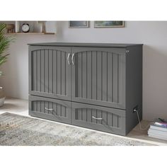 a large gray cabinet with two doors and drawers in the middle of a living room