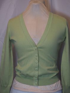 "Item:  Button up cardigan sweater, lightweight Size:  Small Color(s):  Wasabi green Brand:  Moda International Fabric:  Cotton, nyly Length: 20\" (measured from back neckline to bottom of hem) Chest:  32\"  (measured outside of sweater at the armpits, unstretched) Sleeve: 22\"  (measured from shoulder seam area to hem of cuff) More good things about this item:  Soft knit fabric, vintage 2000-2003, excellent condition. Please let me know if you have any questions. My vintage clothing item(s) have been stored in a protective container in a dry area. They might have a slight \"storage\" scent, and should be washed or cleaned accordingly. Visit my shop for more vintage clothing, collectibles, household items, and handcrafted jewelry! Get free shipping on orders over $35. https://www.stonecott Green Cotton Long Sleeve Cardigan, Green Button-up Cotton Cardigan, Green Cotton Button-up Cardigan, Classic Green Cotton Cardigan, Green Cotton V-neck Cardigan, Green Fitted Casual Cardigan, Fitted Green Casual Cardigan, Green Cotton Sweater With Button Closure, Classic Green Long Sleeve Cardigan