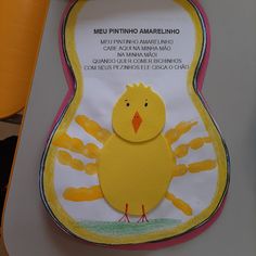 a sign with a yellow bird on it's back and handprints in the background