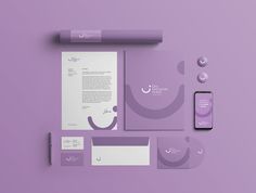 the stationery is laid out on top of the purple surface