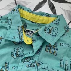 Osh Kosh New With Tags Buttondown. Teal With Old Stool Games Pattern In Yellow/Navy. Never Pulled Out Of Drawer - My Loss. Size 18 Mo. Cute Blue Button-up Shirt, Playful Short Sleeve Tops With Pockets, Cotton Tops With Pockets For Playtime, Casual Tops With Pockets For Playtime, Short Sleeve Tops With Pockets For Playtime, Blue Short Sleeve Top For Playdate, Cute Tops With Pockets, Cute Blue Tops With Pockets, Cute Button-up Shirt With Details