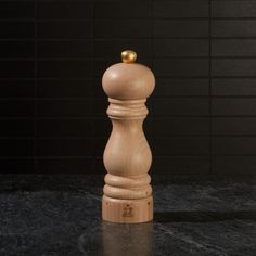 a wooden pepper mill sitting on top of a counter