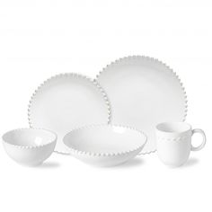 white dishes and cups with scalloped rims on a white background, one is empty