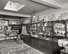 an old black and white photo of the inside of a grocery store with many items on display