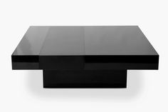 a black coffee table with two square sections on it's sides and one section at the top