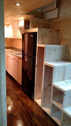 a kitchen with wood floors and cabinets in it