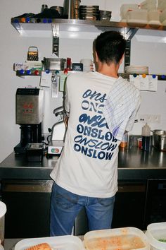 a man standing in front of a counter filled with food