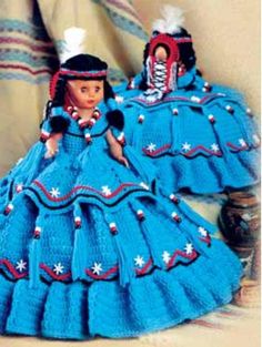 two crocheted dolls dressed in blue dresses