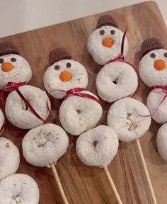 there are snowmen made out of doughnuts on sticks