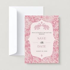 save the date card with an elephant and floral pattern on it, next to a white envelope