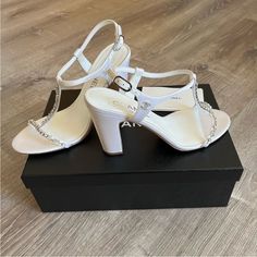 In New Condition!! Never Worn Outside Only Inside To Try The Shoes On! Rare Find And The Perfect White Heel Or Wedding Shoe! About 3.75 Inch Heel Size 38 In Chanel But Fits More Like A 37.5 Or 7 1/2 Comes With Box! Designer White Embellished Sandals, Luxury White Heels With Rhinestones, White Rhinestone Sandals For Formal Occasions, Luxury Rhinestone Block Heel Heels, Luxury Rhinestone Block Heels, Designer White Heels With Rhinestones, White Designer Heels With Rhinestones, Elegant Crystal Embellished Round Toe Sandals, Elegant White Sandals With Rhinestones