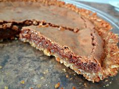 there is a chocolate pie with one slice taken out of it's crusts