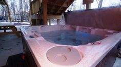 an outdoor hot tub in the middle of winter