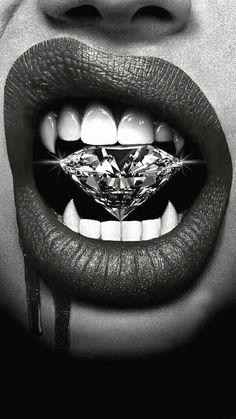 a woman's mouth with a diamond in the middle of her lip and teeth