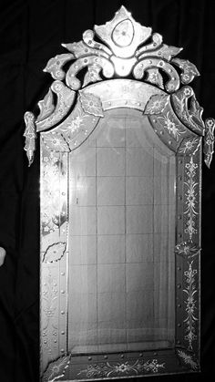 an ornately designed mirror is shown against a black background