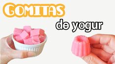 two hands are holding small pieces of pink candy in front of the words comitas de yogurr