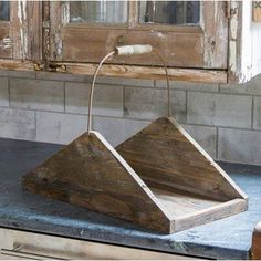 two wooden trays sitting on top of a counter next to an old window sill