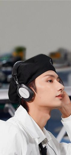 a young man wearing headphones while sitting down