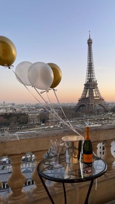 champagne and balloons floating in front of the eiffel tower