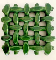 a close up of a green tile design