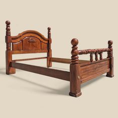 a wooden bed frame with posts and headboard