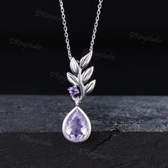 Admire the stunning hues of lavender and violet, each Amethyst necklace exudes charming elegance and offers a gateway to inner calmness, providing a sanctuary from the hustle and bustle of everyday life and keeping the wearer intoxicated. This exquisite Amethyst necklace is believed to bestow fortune, blessings, and wealth, making it an ideal gift for your loved ones, family and friends. INSPIRATION GIFTS CHOICE : The leaf  Lavender Amethyst necklace comes in a delicate jewelry box, it is a good Olive Leaf Necklace, Lavender Amethyst, Olive Leaf, Birthstone Gifts, February Birthstone, Wedding Jewellery Necklace, Vintage Purple, Delicate Jewelry, Amethyst Necklace