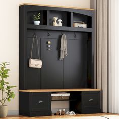 an entryway with a bench, coat rack and purses on the shelf next to it