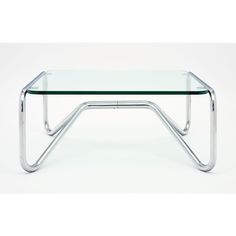 a glass and chrome coffee table with an angled metal frame on the bottom, against a white background