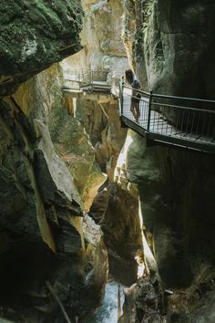 a person standing on a bridge over a river