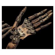 an old wooden and metal skeleton hand holding something