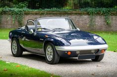 a blue sports car parked on the side of a road