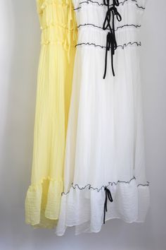 This Alora dress is sure to brighten up any day! The dress features an adjustable shoulder strap, ruffle detail and bow trim, contrast trim color on white color, and a flowy skirt, invisible zipper at back center, Lined. 100% Polyester Trim Contrast, Flowy Skirt, Trim Color, Contrast Trim, Invisible Zipper, White Color, The Dress, White Dress, Shoulder Strap