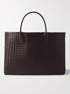 Matthieu Blazy places Bottega Veneta at the forefront of the big bag comeback, the Creative Director's versions feel particularly relaxed due to their slouchy shapes. This style is made from leather using the signature intrecciato weaving technique and has two smooth top handles that fit comfortably over the shoulder. The generous interior easily fits your gym sneakers, a change of clothes and laptop. Classic Woven Leather Shopping Bags, Classic Woven Leather Bags For Shopping, Classic Tote Bag With Intrecciato Weave, Classic Woven Leather Bag With Double Handle, Classic Woven Leather Tote Bag, Luxury Woven Leather Rectangular Bag, Luxury Rectangular Woven Leather Bag, Business Bags With Braided Top Handles, Business Bags With Braided Handles And Rectangular Shape