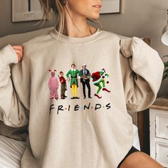 This Friends Christmas Ugly Sweatshirt is a must-have for your winter/Christmas wardrobe. Whether you're attending a Christmas party, staying cozy at home with family and friends, or simply need collecting more sweater-weather crewnecks, this unisex sweatshirt is perfect for you! Our crewnecks are made from the highest quality fabric for an incredibly soft and comfortable fit, with advanced printing and embroidery to ensure that the colors and graphics are vibrant and detailed. ❤ This unisex crewneck sweatshirt is intended to be oversized and loose-fitting for women for a chic and laid-back vibe. If you want something more fitted, we suggest ordering a size down! ❤ How to order your Sweaters: 1. Select the desired Sweater Style/Sweater Color 2. Select the desired Sweater Size 3. Add each s Fun Winter T-shirt With Crew Neck, Funny Graphic Print Sweatshirt For Winter, Funny Long Sleeve Christmas T-shirt, Funny Crew Neck T-shirt For Winter, Funny Cotton Winter Sweatshirt, Funny Cotton Sweatshirt For Winter, Casual Christmas Cotton Sweatshirt, Casual Cotton Christmas Sweatshirt, Fun Crew Neck T-shirt For Winter