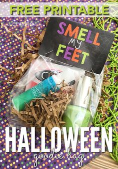 a bag filled with halloween goodies on top of a purple and green table cloth