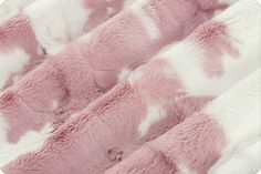 pink and white faux fur with spots on the edges, as well as an animal - like pattern