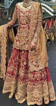 a woman in a red and gold wedding dress