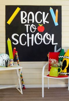 the back to school sign is next to two chairs