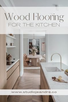 a kitchen with wood floors and white counter tops, the words wood flooring for the kitchen