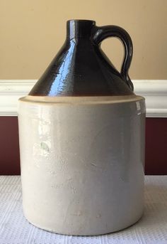 a black and white vase sitting on top of a table