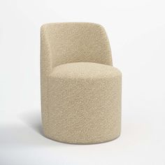 a beige chair sitting on top of a white floor